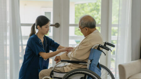 nurse helping patient in wheelchair